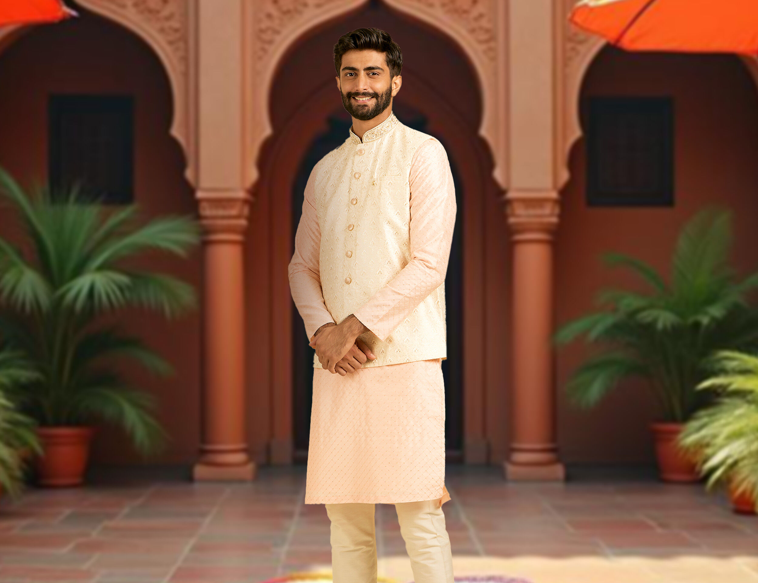 A man wearing pink kurta jacket set